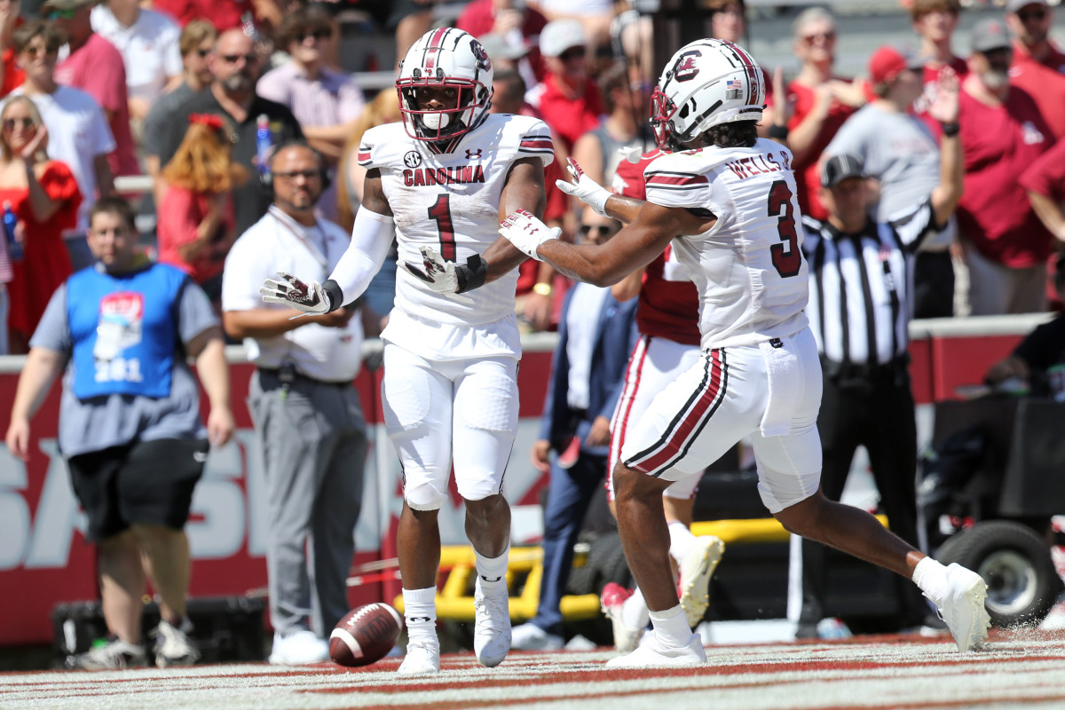 Sep 10, 2022; Fayetteville, Arkansas, USA; South Carolina Gamecocks running back MarShawn Lloyd (1) celebrates with Antewane Wells Jr. (3) after rushing for a touchdown in the second quarter against the Arkansas Razorbacks at Donald W. Reynolds Razorback Stadium. Credit: Nelson Chenault-USA TODAY Sports